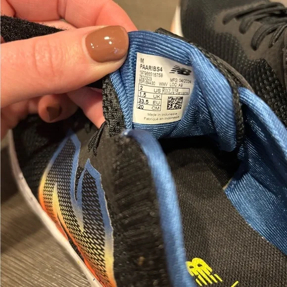 New Balance Kids' Black Sneakers with Blue and Yellow Accents - Picture 2 of 2